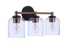 The Coppa - 18719FBSB3 bath vanity light features three lights, a black circular mount, and a horizontal satin brass arm, supporting clear glass shades with individual bulbs.