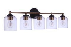 The Coppa - 18733FBSB5 is a modern bath vanity light with five clear glass shades encasing visible bulbs. It features a horizontal alignment with a black round base and a satin brass frame elegantly supporting the shades.